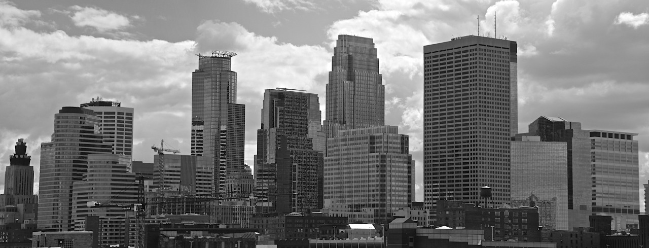 The downtown Minneapolis skyline pressed against a late summer afternoon sky.