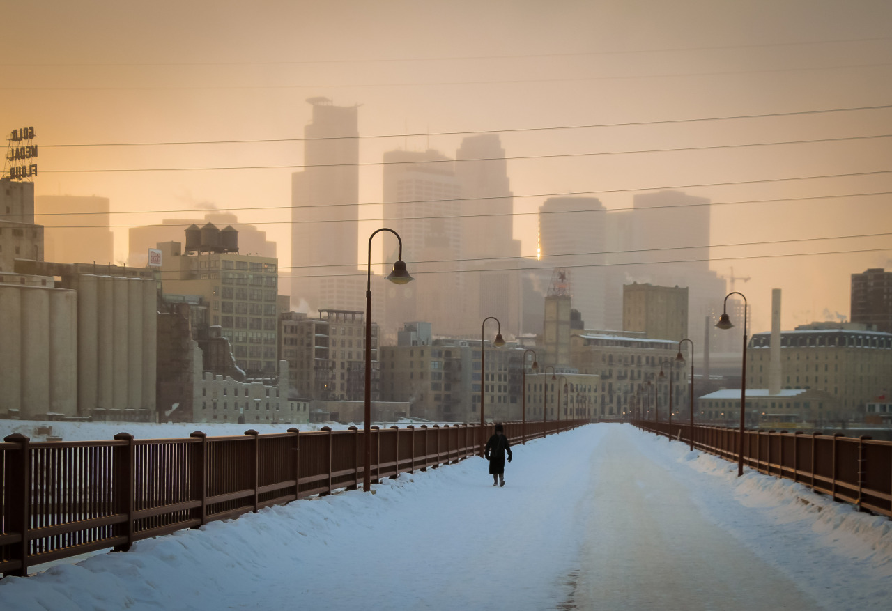 Minnesota Cold. We had a cold sunset today in Minneapolis. Right around 4:30pm a some light snow blew threw casting an awesome shadow on the city. The wind-chills were in the -20+ range today making the streets and the Stone Arch Bridge virtually empty. I’ve never seen the Stone Arch Bridge this empty before. Pretty much all year round the bridge is full of people walking